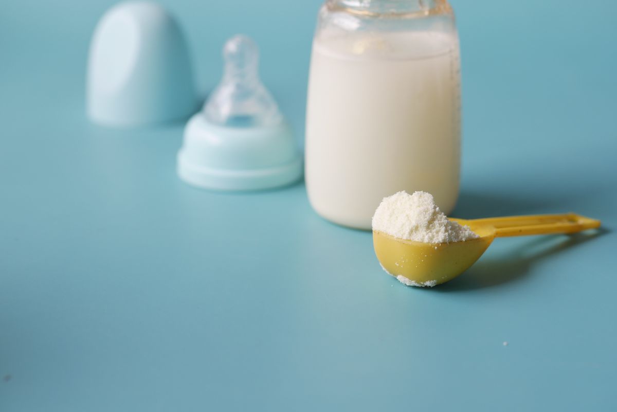Parent bottle feeding a baby — formula feeding guide for UK parents