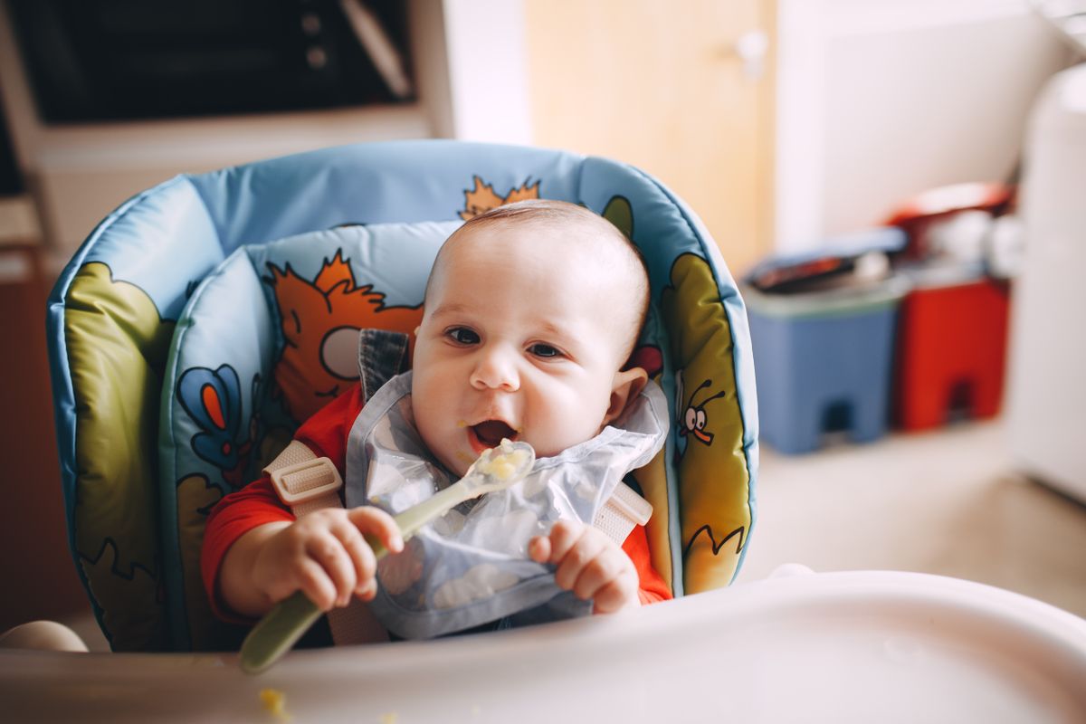 Baby exploring first foods during weaning
