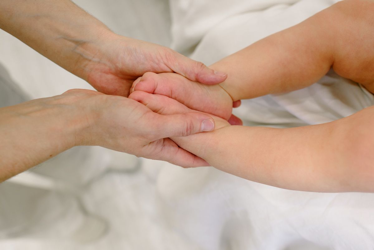 Parent gently caring for baby during unsettled period