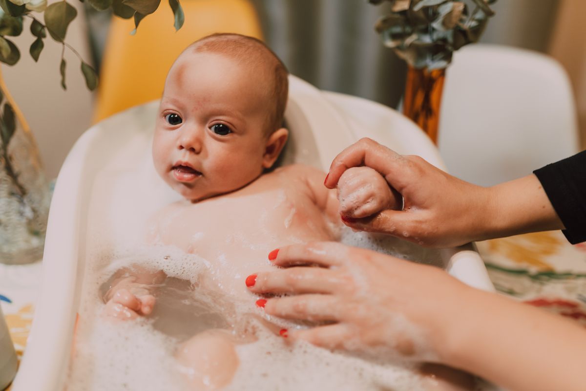 Parent gently comforting and soothing baby
