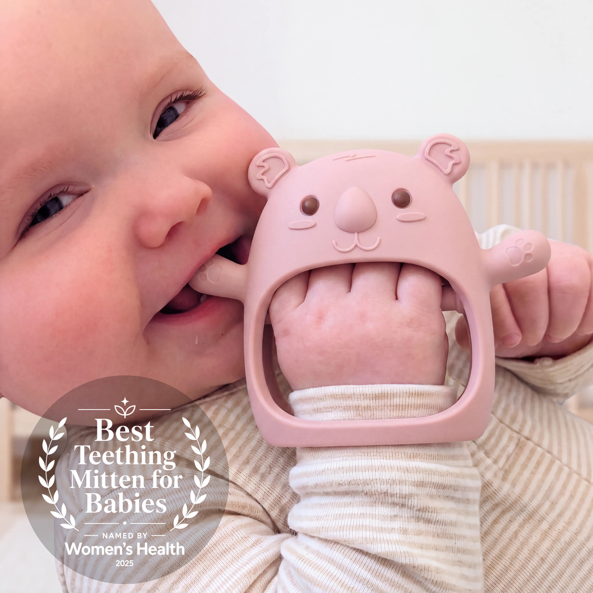 Baby wearing the Plum Koda Koala teething mitten