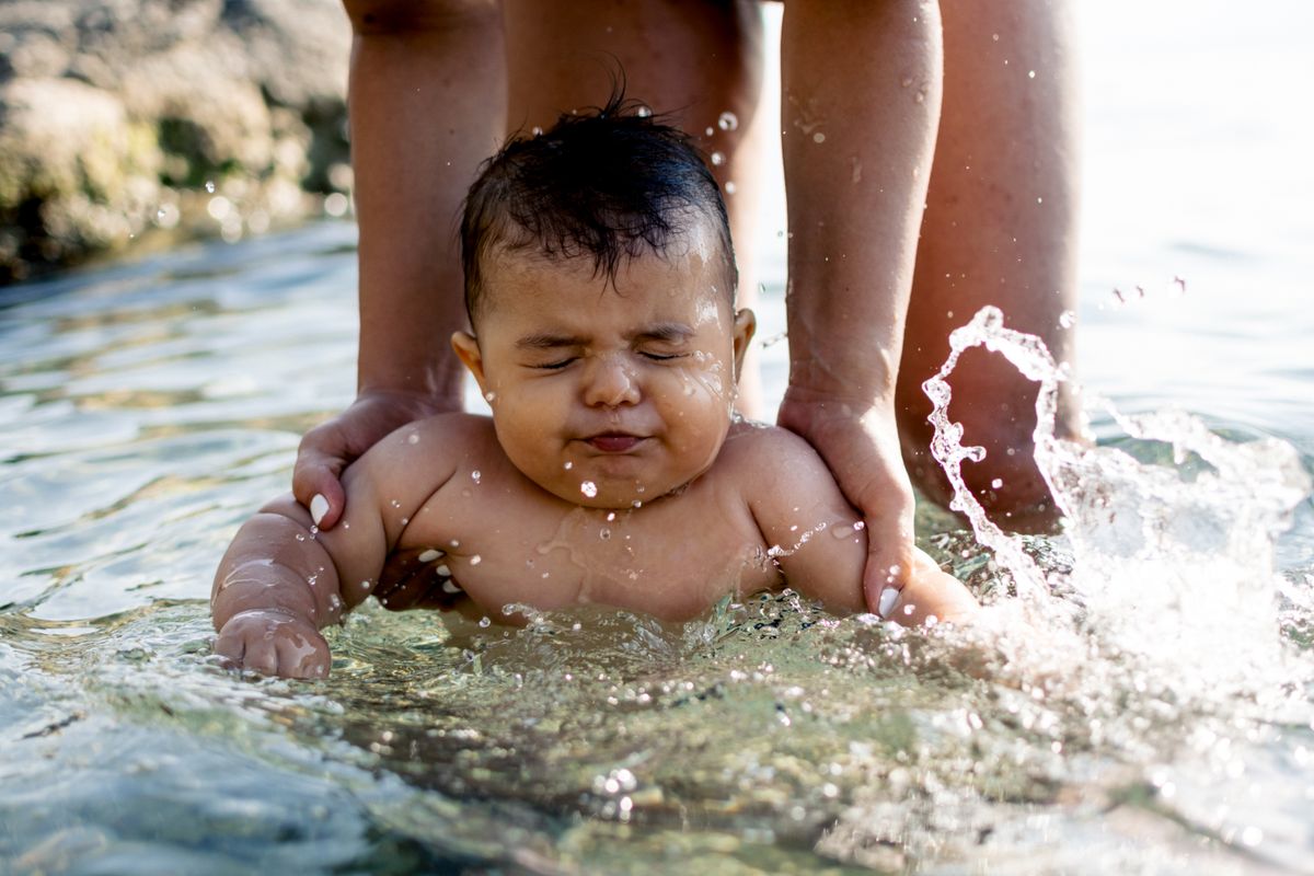 Baby enjoying water and swimming experience