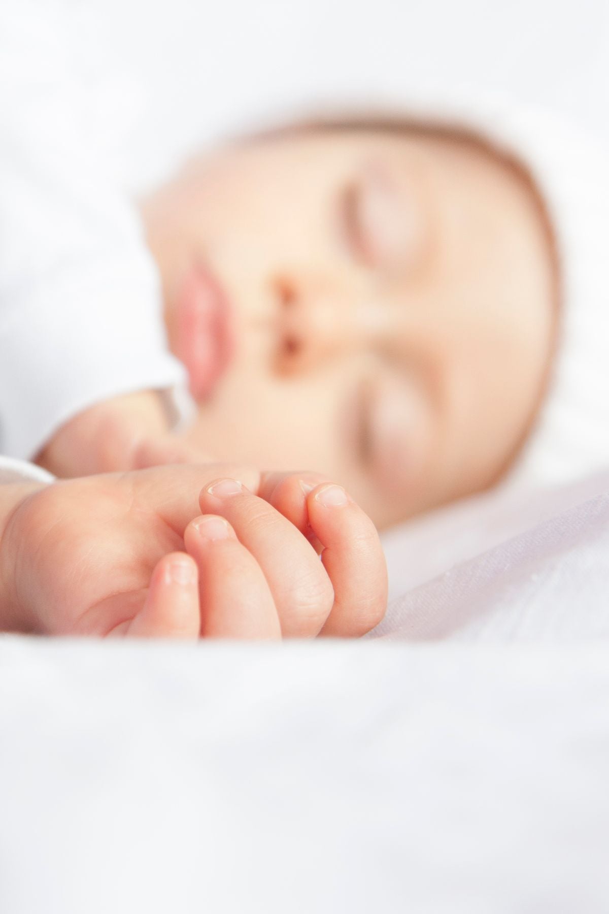 Sleeping baby peacefully in cot
