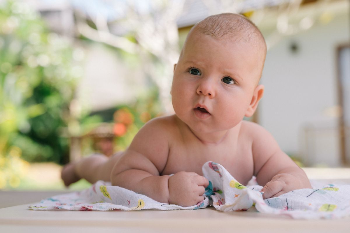 Baby enjoying tummy time on a soft blanket
