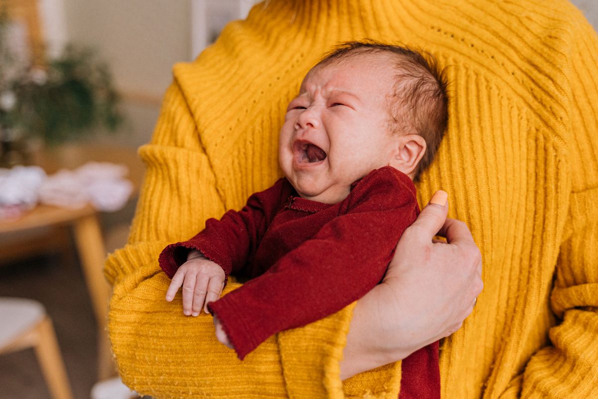 Parent winding a baby over the shoulder — gas and wind relief tips