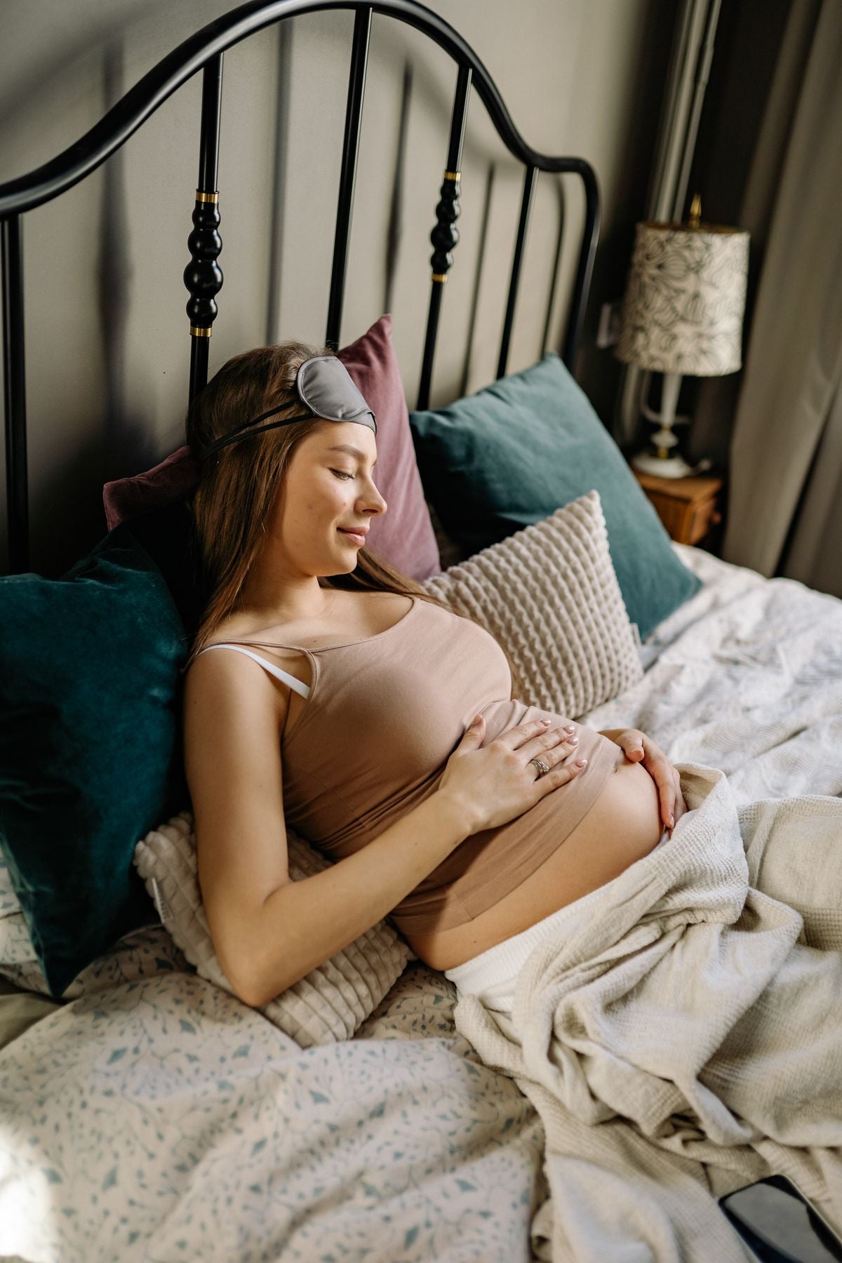 Pregnant woman sleeping comfortably with a pregnancy pillow