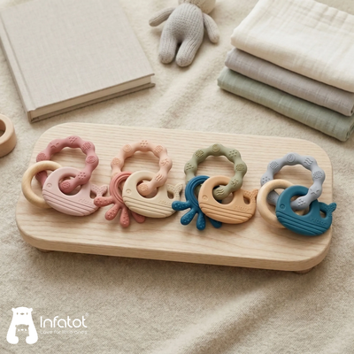 Four colour combinations of the MultiTexture Sea Teether arranged on a wooden tray