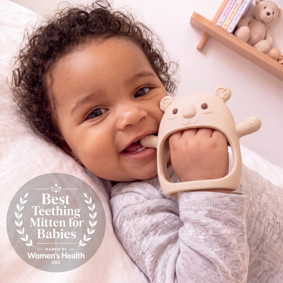 Baby wearing the Cream Koda Koala teething mitten