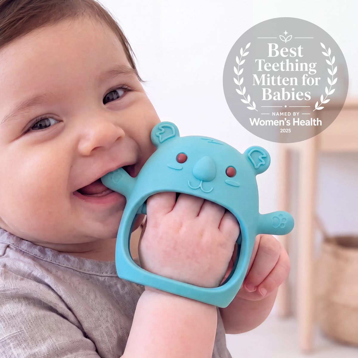 Baby wearing the Teal Koda Koala teething mitten