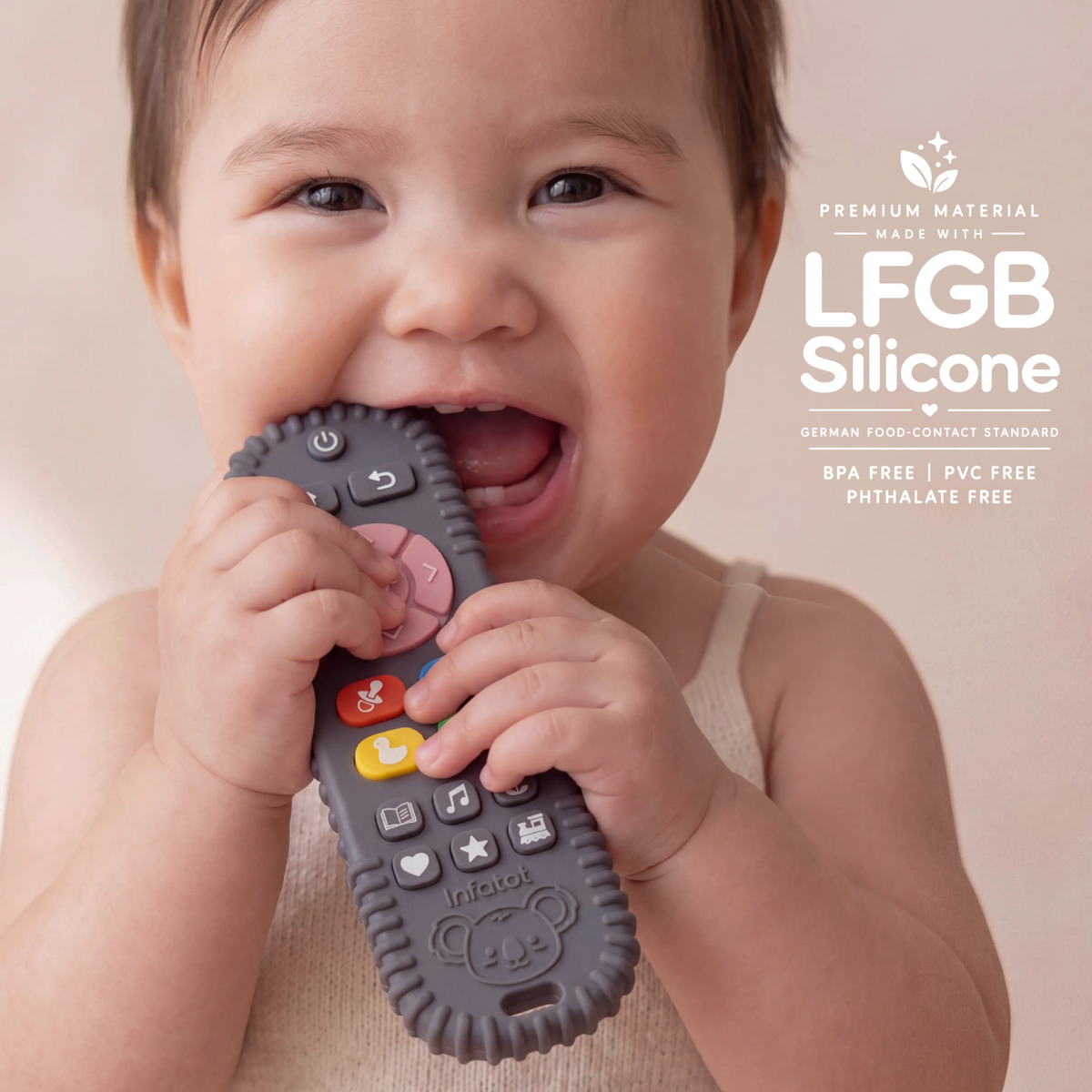 Baby chewing the remote-shaped teether from the Plum Koda Koala pair