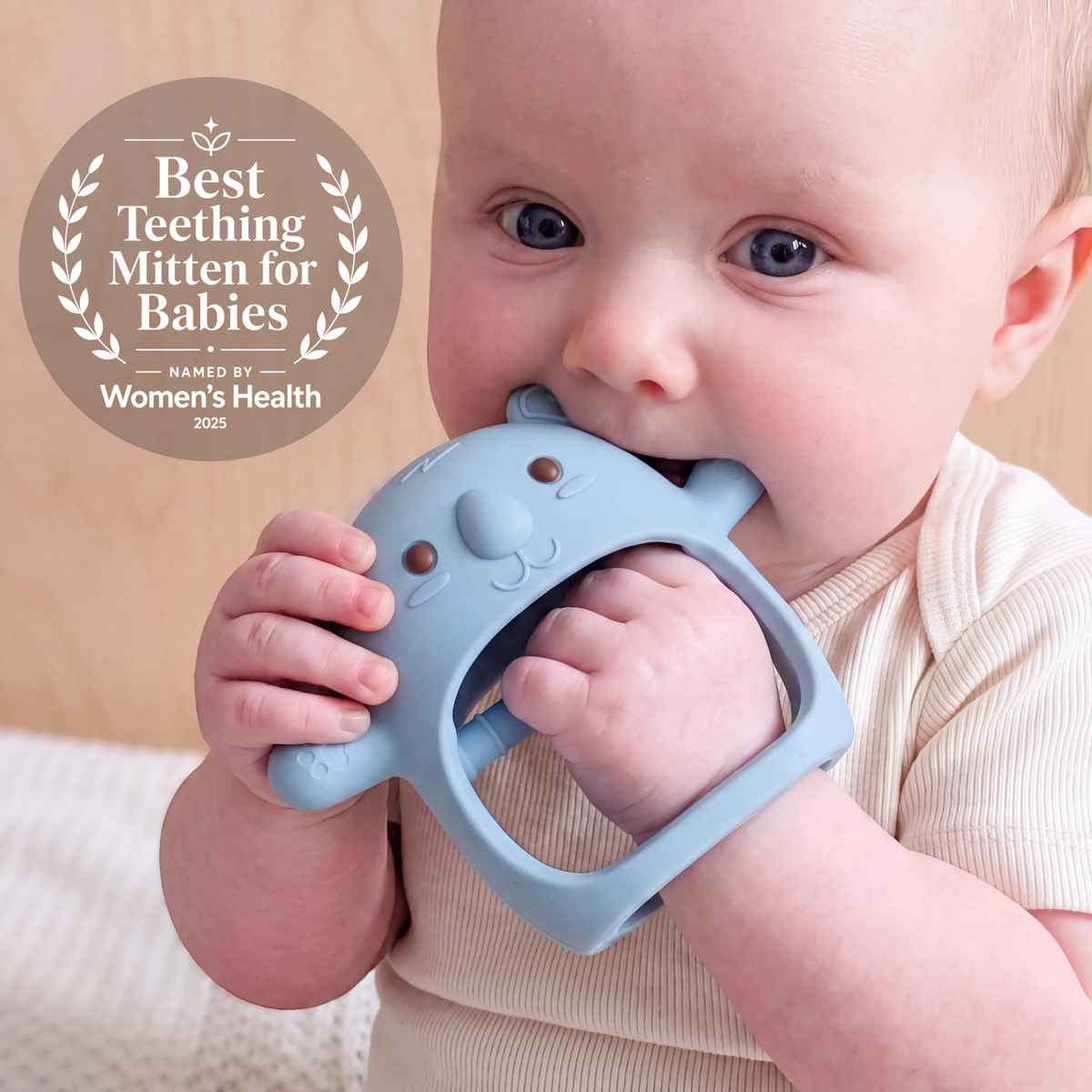 Baby wearing the Blue Koda Koala teething mitten