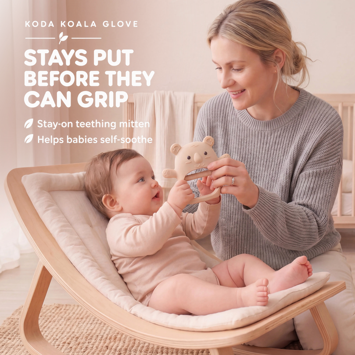 Parent showing a cream Koda Koala teething mitten to a baby in a highchair