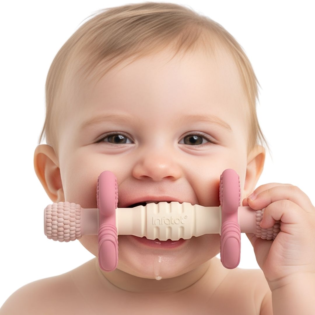 Baby chewing the pink and cream Blush Barbell Buddy teether