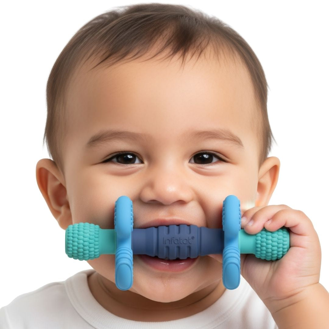 Baby chewing the blue and teal Ocean Barbell Buddy teether