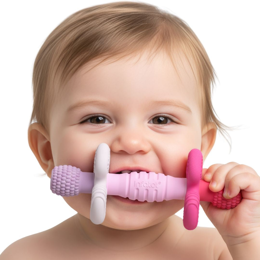 Baby chewing the pink and lilac Petal Barbell Buddy teether