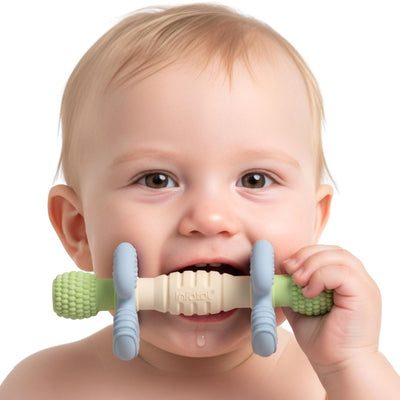 Baby chewing the green, blue and cream Sage Barbell Buddy teether