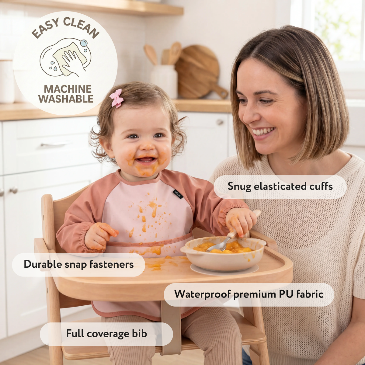 Parent beside a baby wearing a pink coverall bib, with cuffs, snaps and fabric highlighted