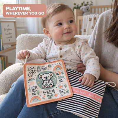 Baby sitting on a parent's lap with the illustrated and striped sides of Koda Koala crinkle sheets